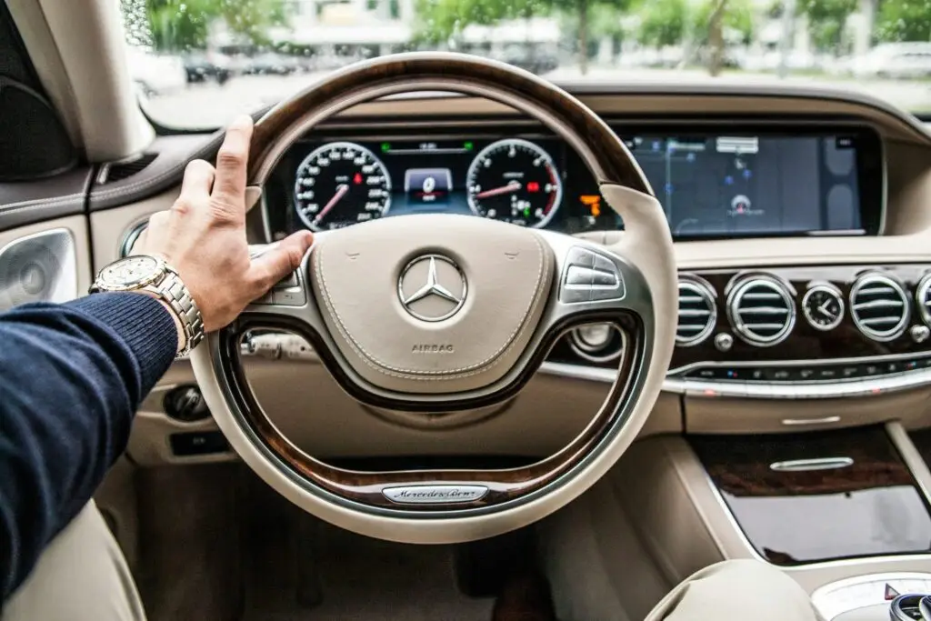 person sitting in Mercedes-S class driver’s seat. Beautiful beige interior