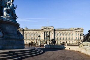 Stunning view of Buckingham Palace with clear blue skies and iconic statues in London, England.