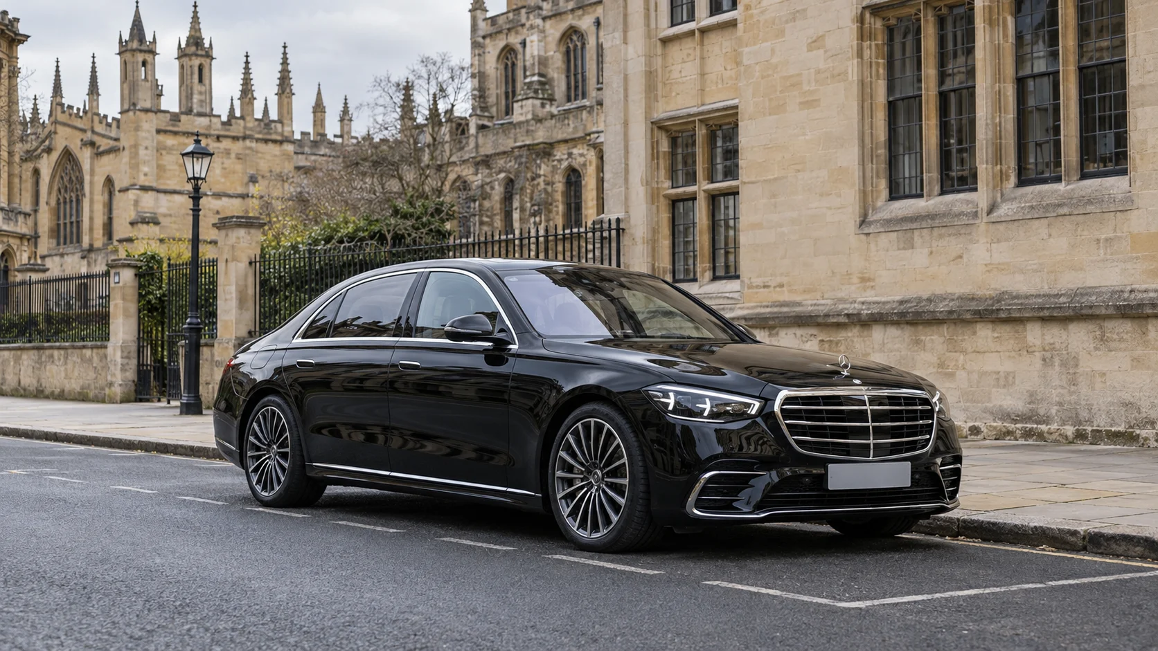 Black Mercedes-Benz S-Class parked beside historic Oxford buildings