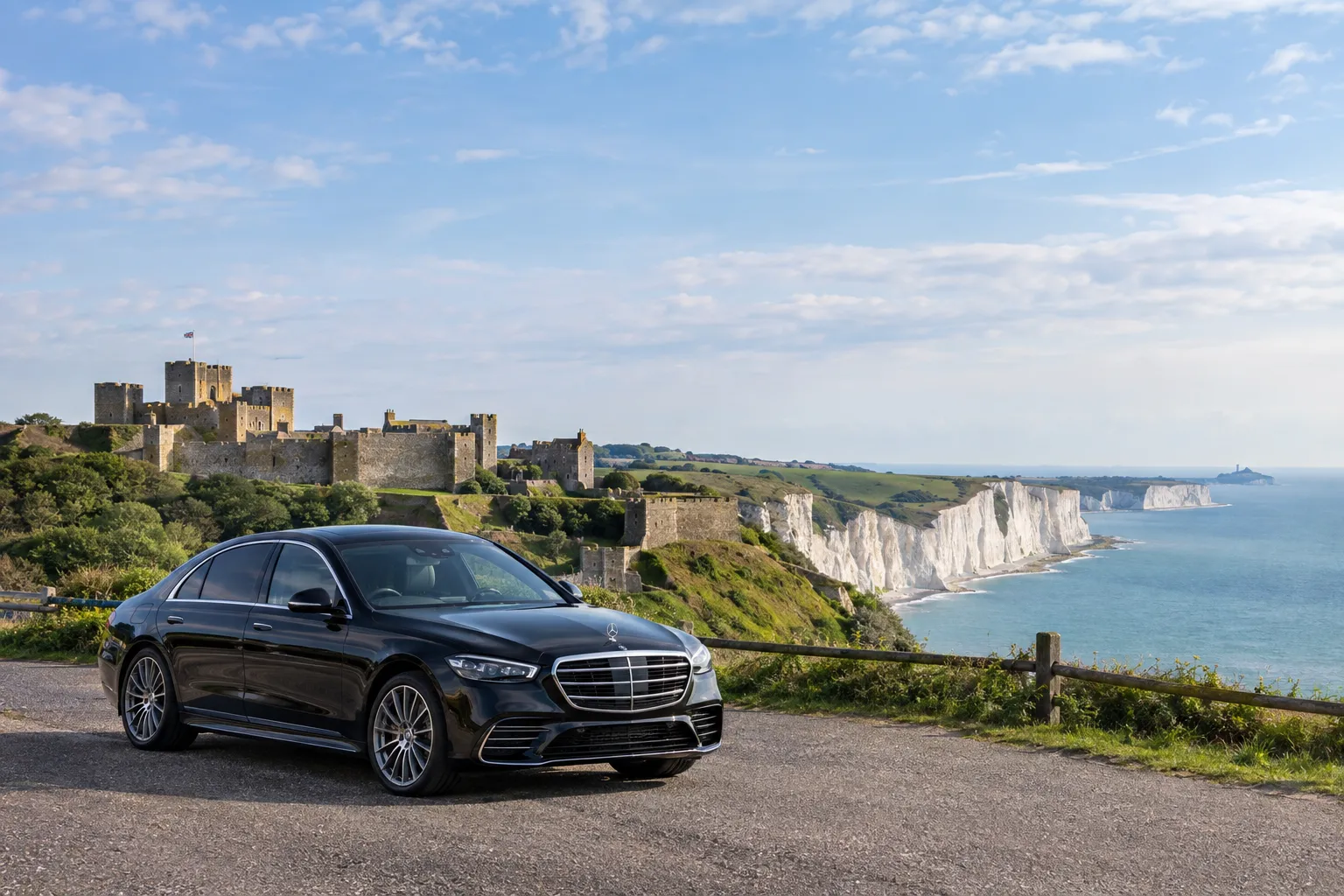 Dover Castle and White Cliffs with Mercedes S-Class executive car in foreground