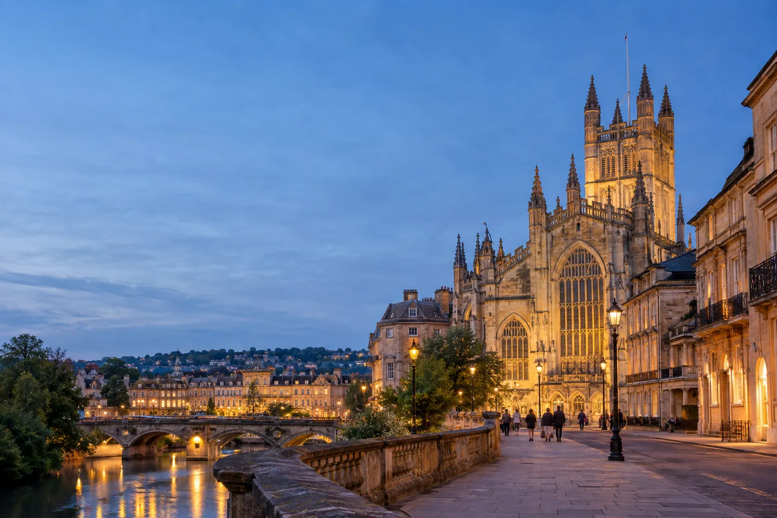 Bath Abbey and the historic city centre illuminated at dusk.